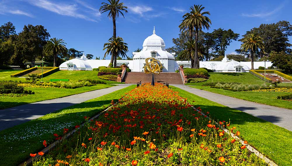 Golden Gate Park in San Francisco on a weekend, with the Conservatory of Flowers and flower beds
