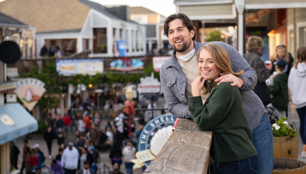 Couple taking a photo at Pier 39 in San Francisco
